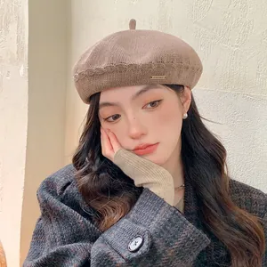 Stylish brown knitted beret hat for women with breathable mesh and metal tag detail