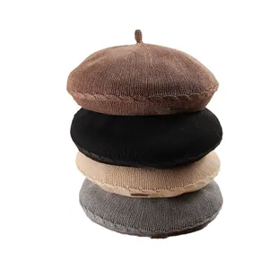 Stylish stack of four fashionable knitted berets for women in assorted neutral colors