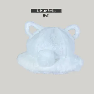 Close-up view of a white fluffy faux fur bucket hat featuring cute animal ears for winter