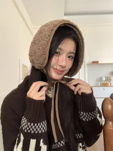 Cozy brown sherpa ear muffs with adjustable ties for winter warmth and comfort