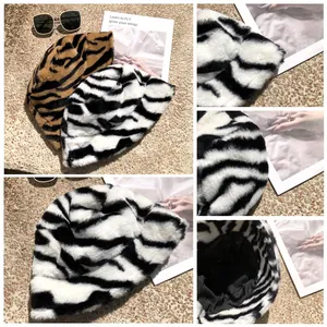 Close-up detail shots showing texture and lining of plush zebra stripe bucket hats