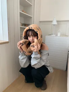 Detailed view of women's plush leopard print hooded scarf for winter warmth
