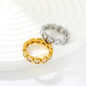 Detailed view of gold and silver plated eternity rings with white cubic zirconia stones