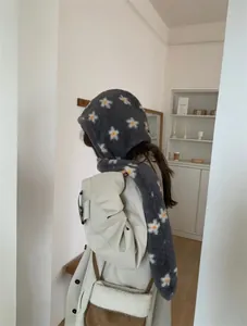 Grey plush hooded scarf featuring white and yellow floral patterns shown from a side profile
