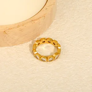 Macro detail of a gold plated stainless steel eternity ring with round white zircon