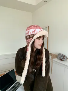 Side view of woman wearing plush Fair Isle aviator hat for winter ear protection