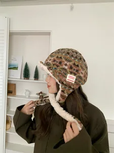 Close-up of Fair Isle plush trapper hat with warm ear flaps and strap detail