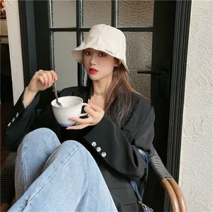 Fashionable pleated beige sunshade bucket hat for women shown in a lifestyle scene