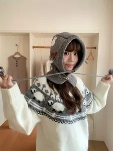 Asian woman wearing a thick knitted Balaclava hood with cute sheep pattern design
