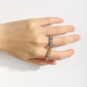 Detailed view of gold and silver stainless steel rings featuring heart-shaped zircons