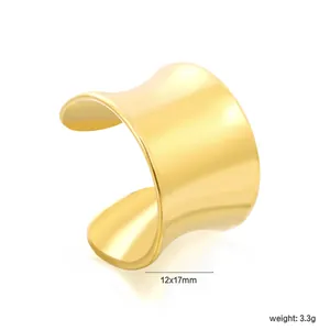 Macro view of a minimalist gold plated stainless steel C-shaped ear cuff jewelry piece