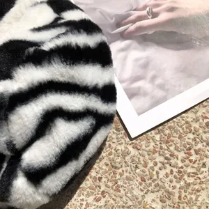 Close-up of soft plush texture on a black and white zebra stripe winter bucket hat