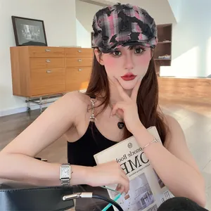 Detail shot of a vintage distressed plaid beret worn by a model in a stylish room