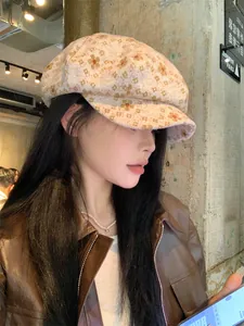 Asian model wearing a stylish floral patterned newsboy hat in a vintage cafe environment