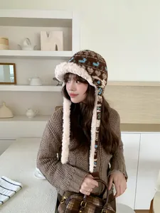 Stylish Fair Isle patterned trapper hat with warm plush lining shown on a model in a cozy setting