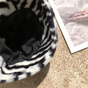 Detailed view of the soft zebra-striped faux fur texture and black lining of a winter bucket hat
