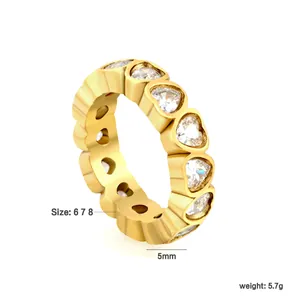 Macro detail of a heart-shaped zircon eternity ring in gold-plated stainless steel.