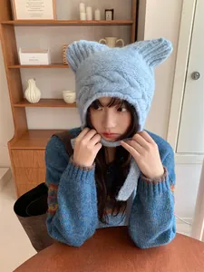Cute light blue cable-knit cat ear beanie with protective earflaps and ties for winter warmth