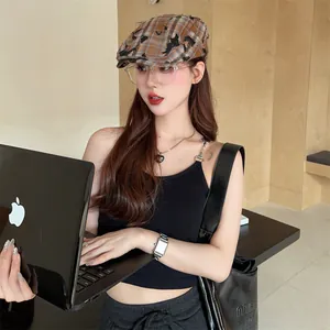 Detailed side view of a vintage plaid distressed newsboy cap worn by an Asian model