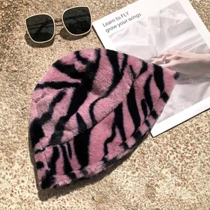 Close-up of stylish pink and black zebra pattern plush bucket hat with soft winter texture