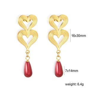 Detailed view of double heart earrings with red teardrop pearls and size specifications