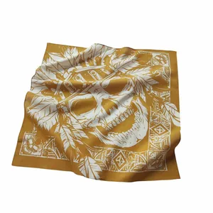 Detailed view of yellow cotton bandana with ethnic Indian skull and feather print