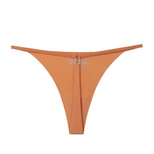 Sexy seamless ice silk T-back thong for women featuring thin straps and elegant gold ring