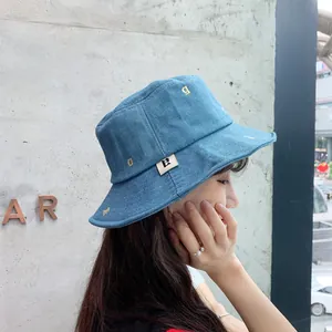 Vista lateral de una mujer elegante con un gorro de pescador de mezclilla azul bordado.