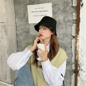 Stylish black pleated bucket hat for women, ideal for sun protection and casual wear.
