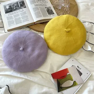 Close-up view of lavender and yellow Japanese style knit berets in a vintage lifestyle setting