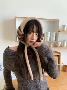 Cozy plush earmuffs with leopard print details and long straps for winter warmth.