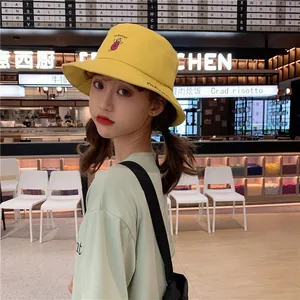Close-up view of a cute yellow bucket hat with sweet eggplant embroidery for girls