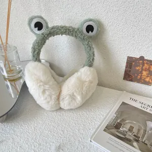 Detail of cute frog-themed plush earmuffs in a cozy indoor lifestyle setting for winter