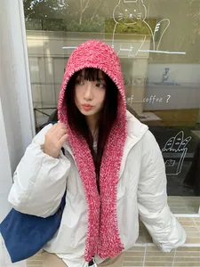 Model wearing a stylish pink and white knitted hood scarf with thick wool texture