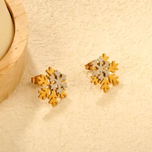 Close-up view of elegant two-tone snowflake stud earrings made of durable stainless steel