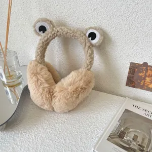 Close-up detail of cute khaki frog-themed plush earmuffs for cozy winter warmth