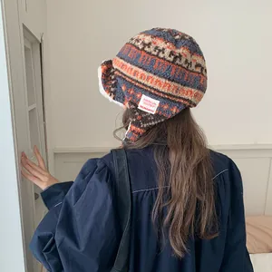 Back view of a cozy Fair Isle patterned plush trapper hat for winter warmth and style