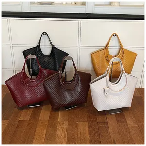 Detailed view of large capacity woven tote bags in various colors on display stands