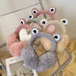 Detailed view of cute plush frog earmuffs in multiple colors showing soft furry texture.