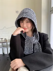 Grey salt and pepper knitted hooded scarf hat on female model for winter style and warmth
