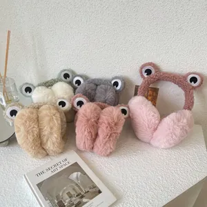 A detailed close-up showing cute frog-themed plush earmuffs in various soft pastel colors.