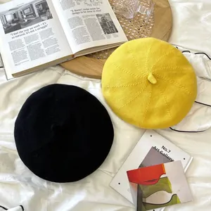 Breathable yellow and black knitted berets in a stylish lifestyle bedroom setup