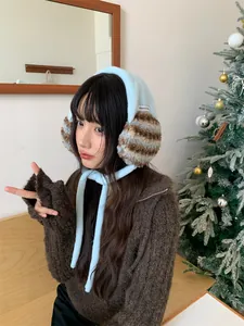 Korean style plush earmuffs for winter shown worn by a model in a cozy indoor setting