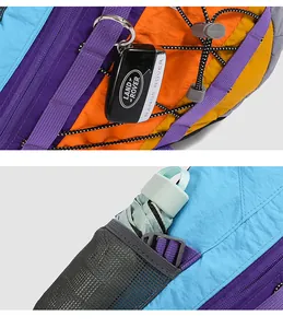 Close-up of vibrant outdoor crossbody bag showing storage pockets and attachment ring