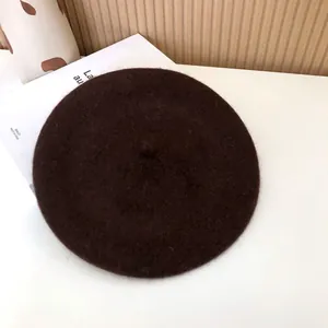 Detailed close-up of a classic dark brown wool felt beret showing soft material texture