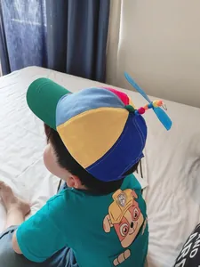 Vibrant multi-colored children's baseball cap featuring a fun spinning blue propeller toy