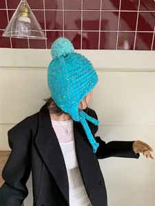 Stylish turquoise confetti knit beanie for women with warm pom-pom and protective ear flaps