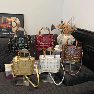 Collection of chic bucket bags with bamboo handles and gold star studs in five colors