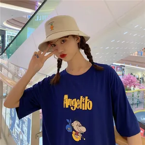 Sweet beige bucket hat with carrot embroidery worn by a model in a casual setting