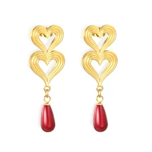 Elegant double heart gold-plated earrings with red teardrop pearl pendants